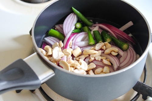 cooking onion, cashews and green chilies