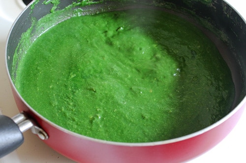 adding blanched, pureed spinach to make palak paneer