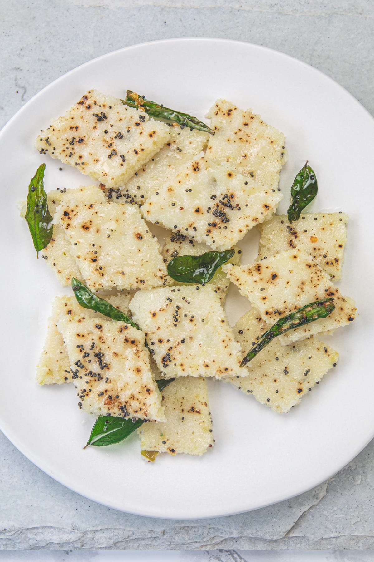 Rava dhokla in a white plate.