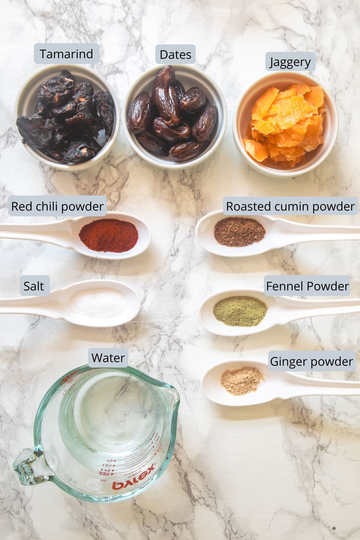 Tamarind date chutney ingredients in bowls and spoons with labels.