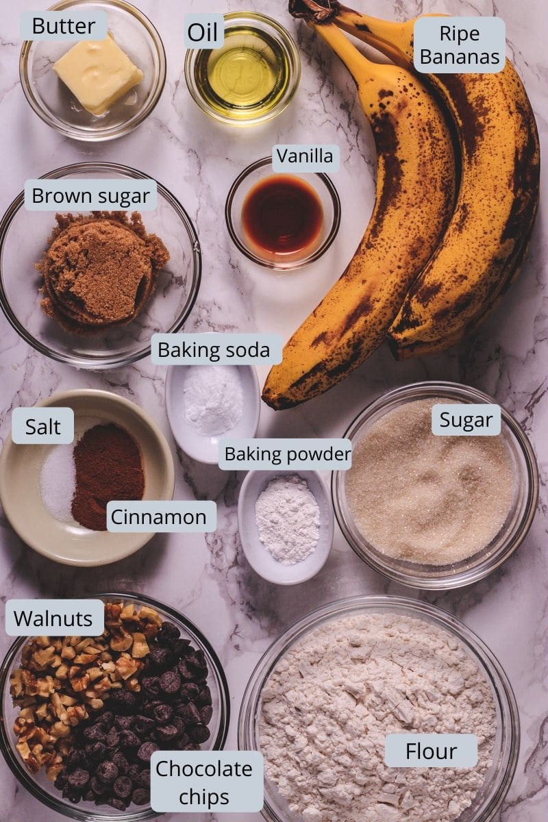 Eggless banana muffin ingredients in bowls and spoons with labels.