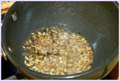 Tempering of mustard and cumin seeds.