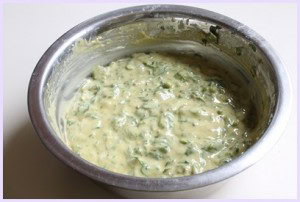 Methi gota batter in a steel bowl.