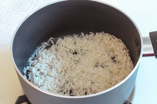 adding soaked, drained basmati rice