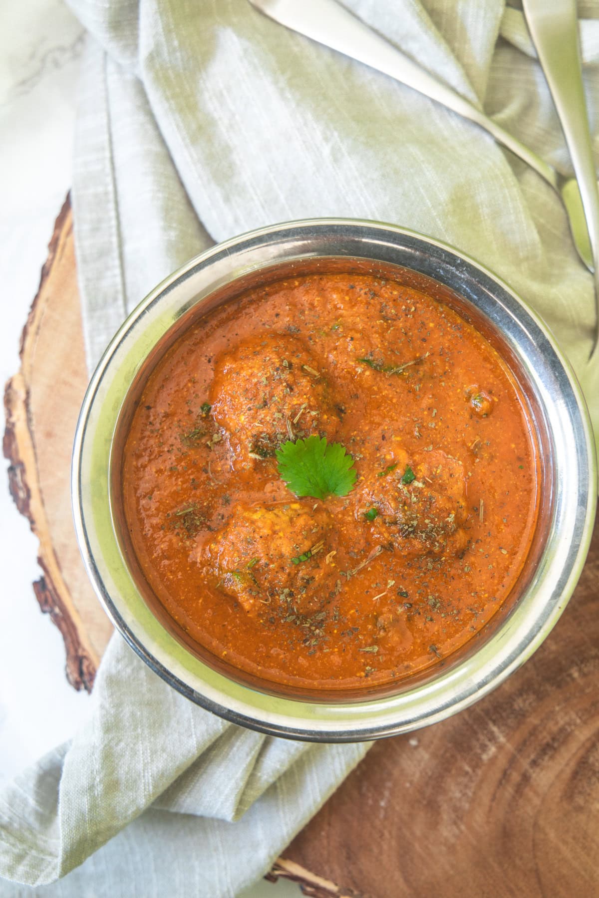 Lauki kofta with a garnish of cilantro and kasoori methi.