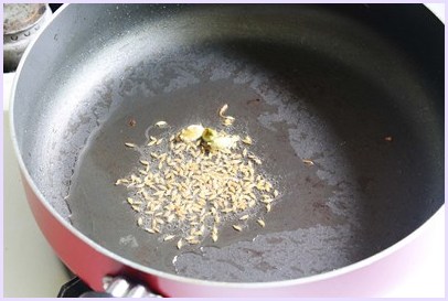 sizzling cumin seeds into hot oil