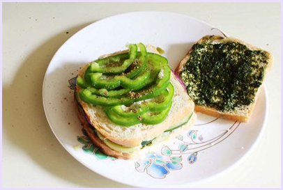 Closing the sandwich and placing capsicum.