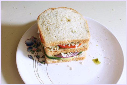 placing another bread slice on top.