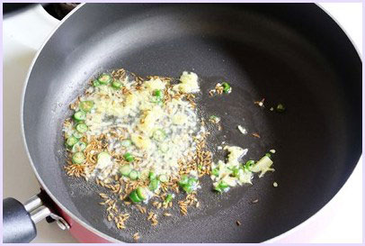 Sauteing ginger, garlic, green chili.