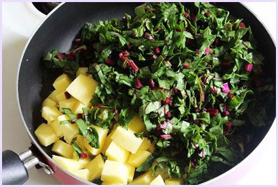 Adding potato and beet greens.