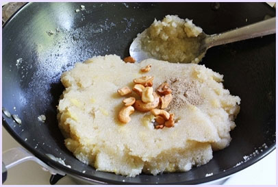 adding fried cashews and cardamom powder