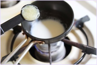 adding ghee into boiling milk