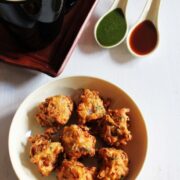 Cabbage pakoda served with chutneys and tea.