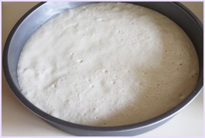 Khatta dhokla batter in a pan.
