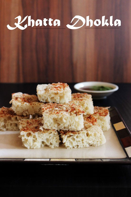 Khatta Dhokla in a plate with chutney in the back.