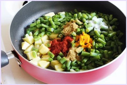 Adding aloo, beans and spices.