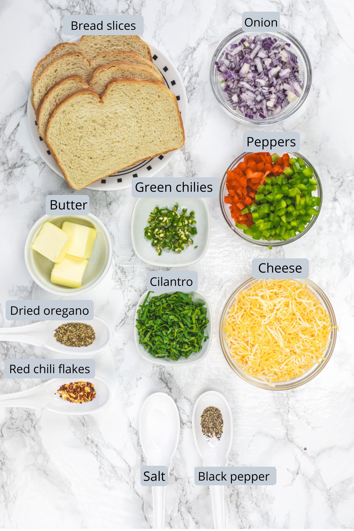 Chilli cheese toast recipe ingredients in bowls and spoons with labels.