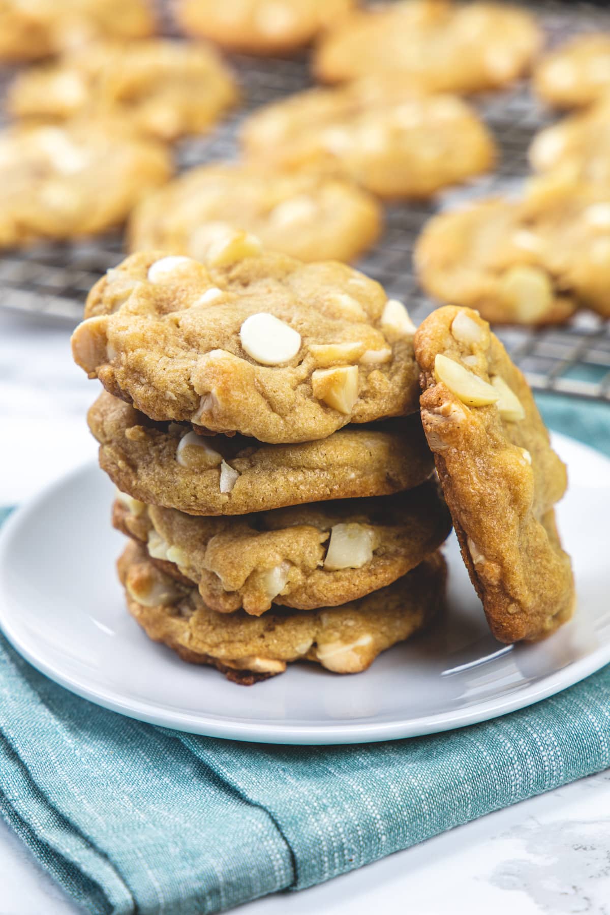 A stack of white chocolate macadamia nut cookies in a plate.