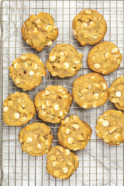 White chocolate macadamia nut cookies on a cooling rack.