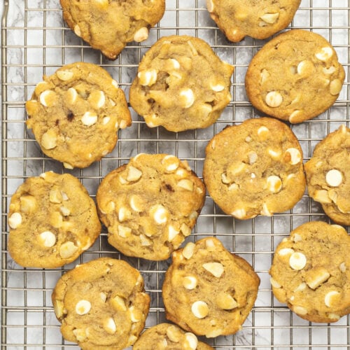White chocolate macadamia nut cookies on a cooling rack.