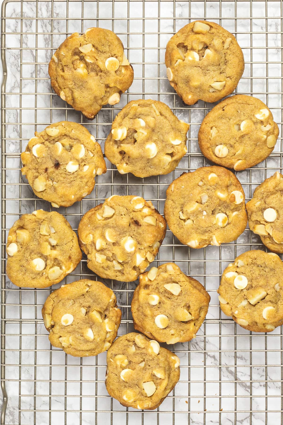 White chocolate macadamia nut cookies on a cooling rack.