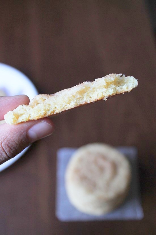 Eggless snickerdoodle cookie cut into half to show inside texture.