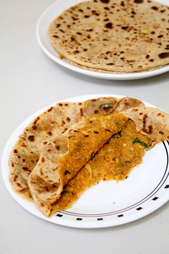 Gobi paratha cut into half to show inside.