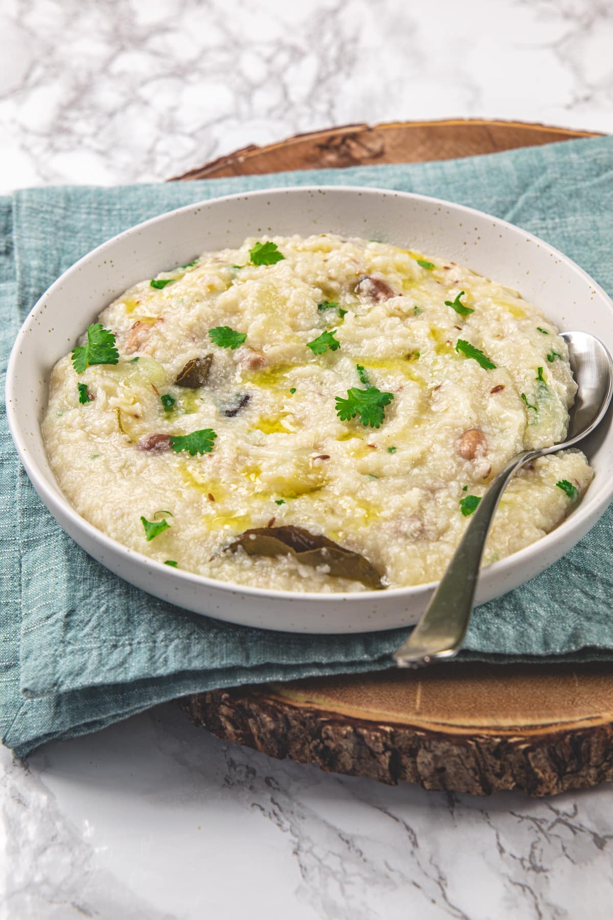 Moraiyo khichdi in a plate with spoon and napkin under the plate.