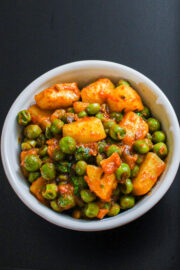 Dry aloo matar served in a white bowl.