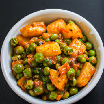 Dry aloo matar served in a white bowl.