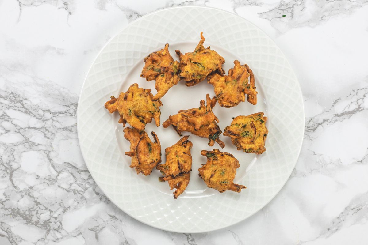 Pakora in a plate with kadhi pakora.