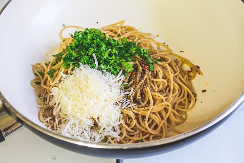 adding salt, pepper, parsley and parmesan cheese