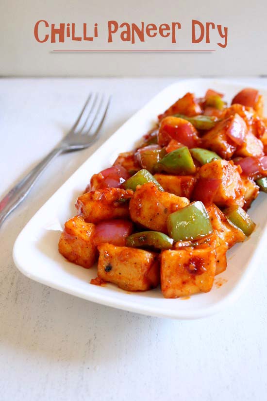 Chilli Paneer in a plate with fork on the side.