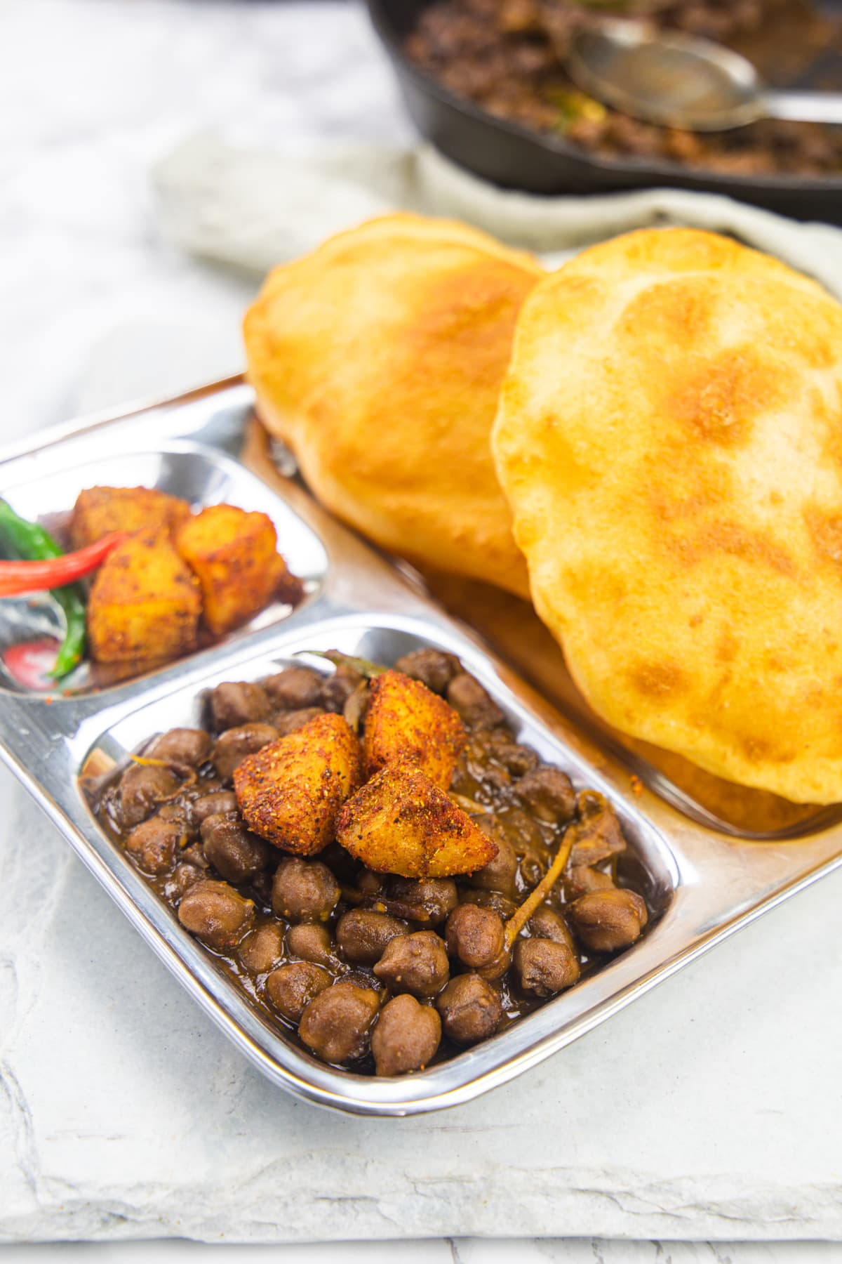 Chole bhature with khatte aloo and bhatura.