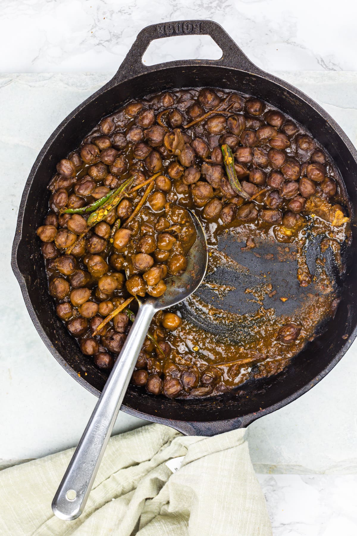 Chole curry pan with serving spoon.