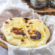 Naan in a parchment paper lined basket.