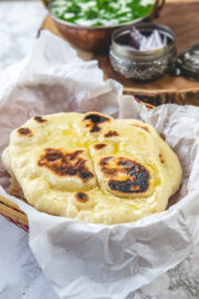 Naan in a parchment paper lined basket.