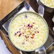 A bowl of sabudana kheer with spoon on the side.