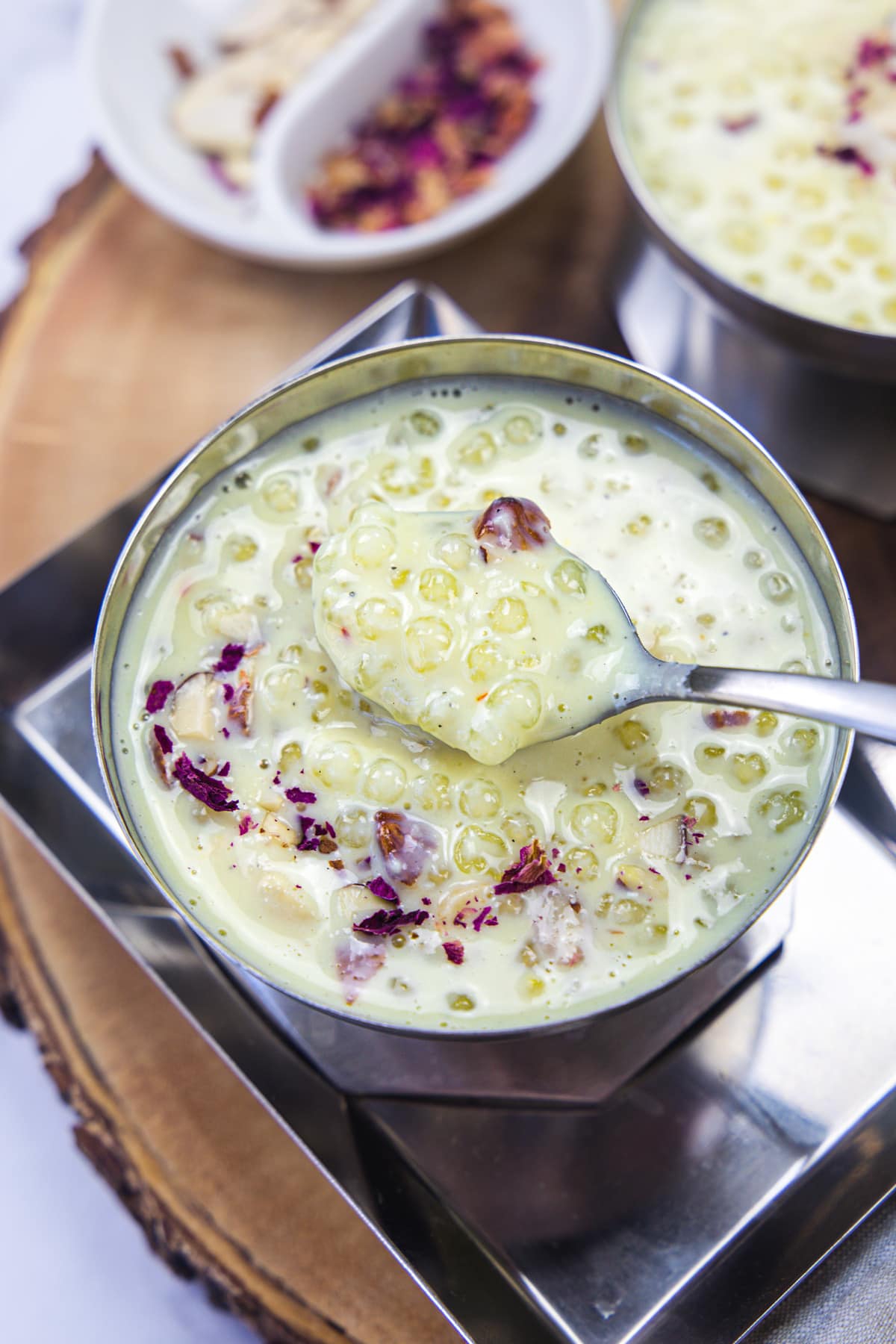 Taking a spoonful of sabudana kheer from the bowl.