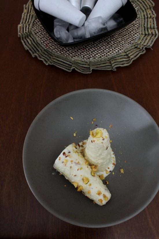 Malai Kulfi garnished with nuts.