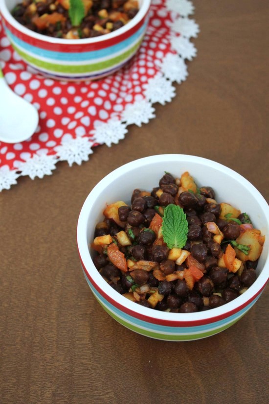 Kala Chana Chaat in a bowl garnished with mint.