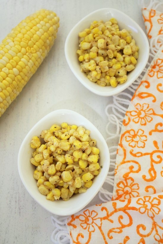 Cup corn in two bowls with a corn on the cob on the side.