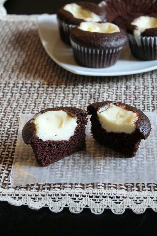 Eggless black bottom cupcakes cup open in half.