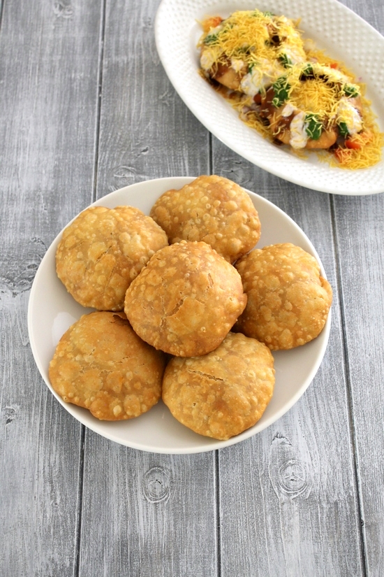 Khasta kachori in plate with kachori chaat plate in the back.