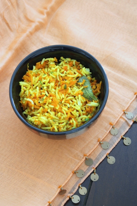 Carrot rice served in a black bowl.