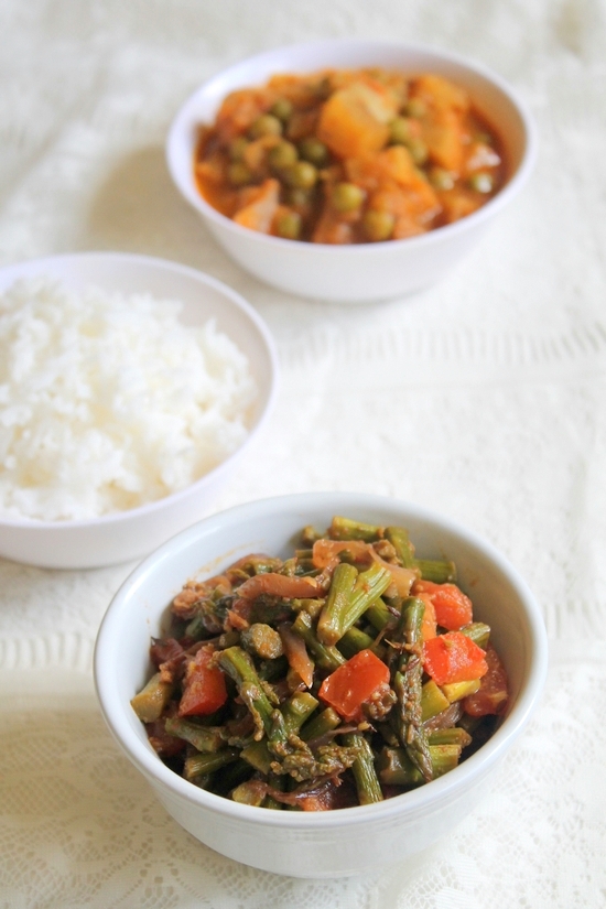 Asparagus Subzi in a bowl with a bowl rice and another sabzi in the back.