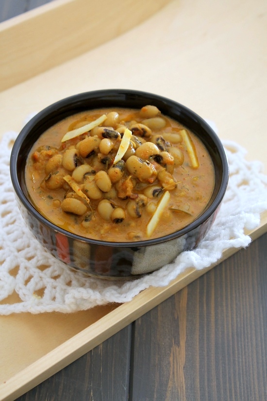 Lobia curry in a bowl garnished with ginger slices.