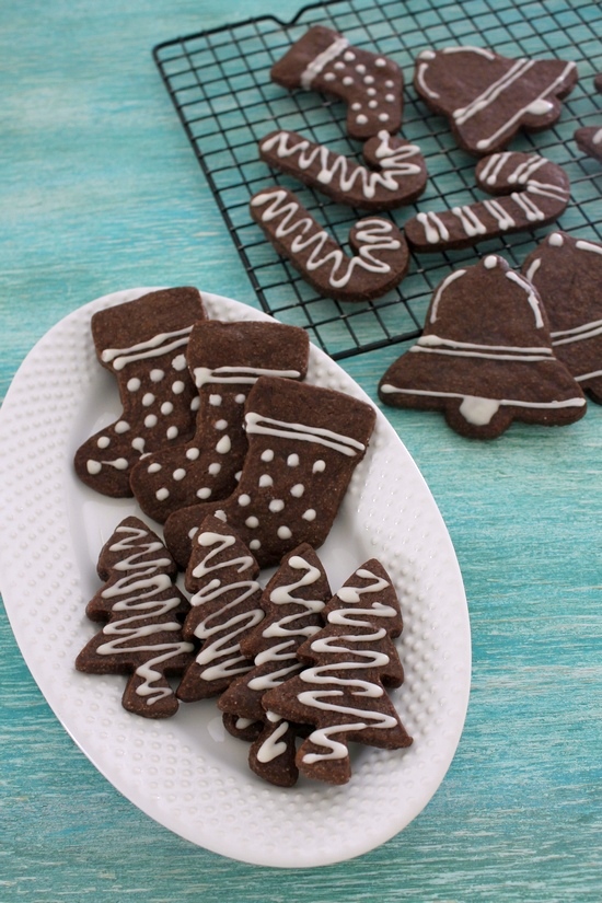 Eggless chocolate sugar cookies in a plate and few more on a cooling rack.