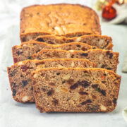 Slices of eggless fruit cake on a marble board.