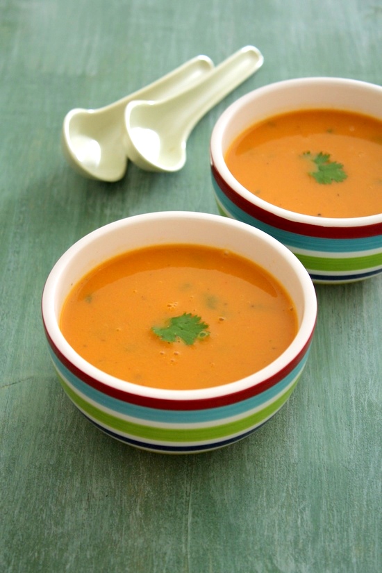 Tomato shorba in 2 bowls garnished with cilantro.